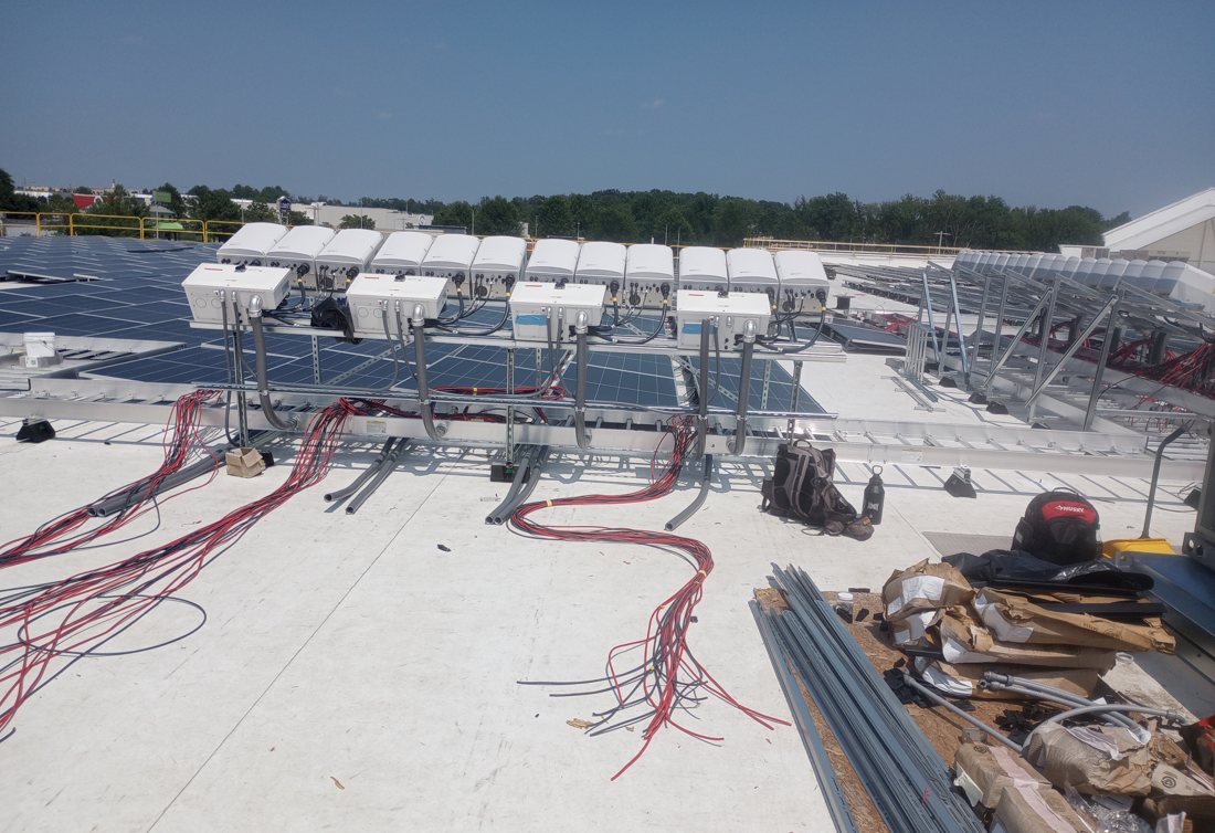 Inverter bank and solar array on the Abingdon rooftop, July 2026